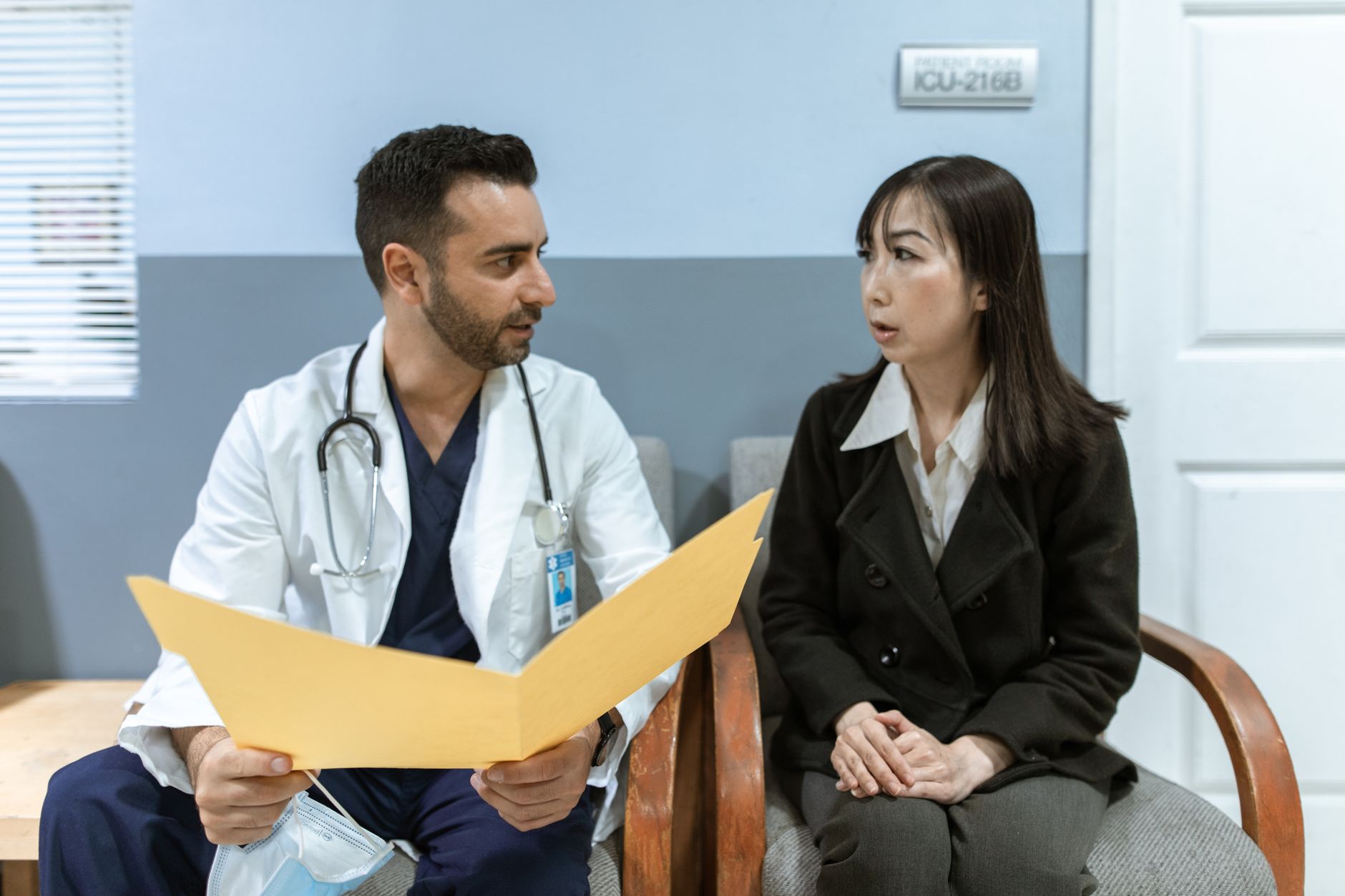 Healthcare professional consulting a patient in a clinical setting