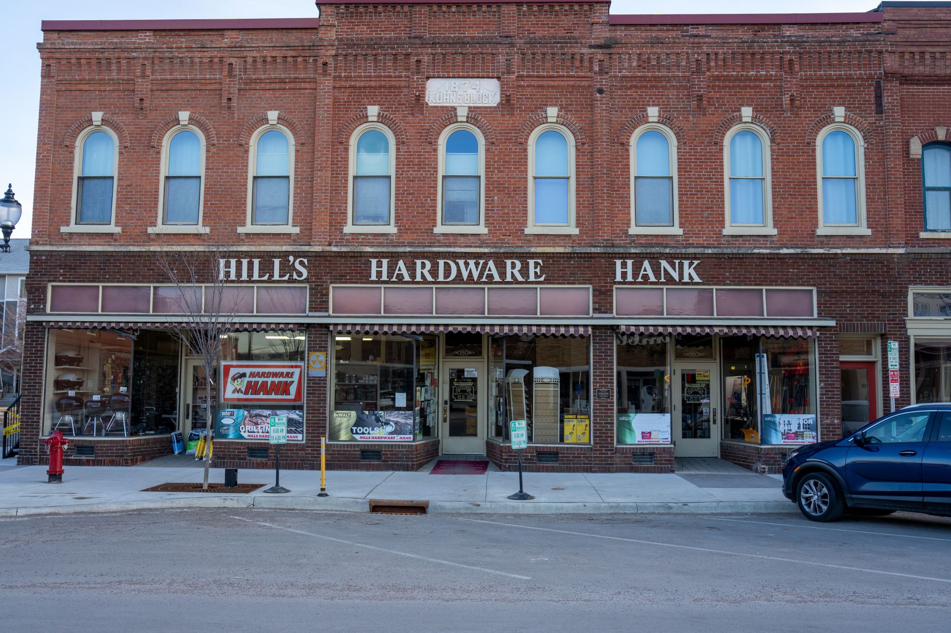 Charming brick facade of a classic neighborhood hardware store.