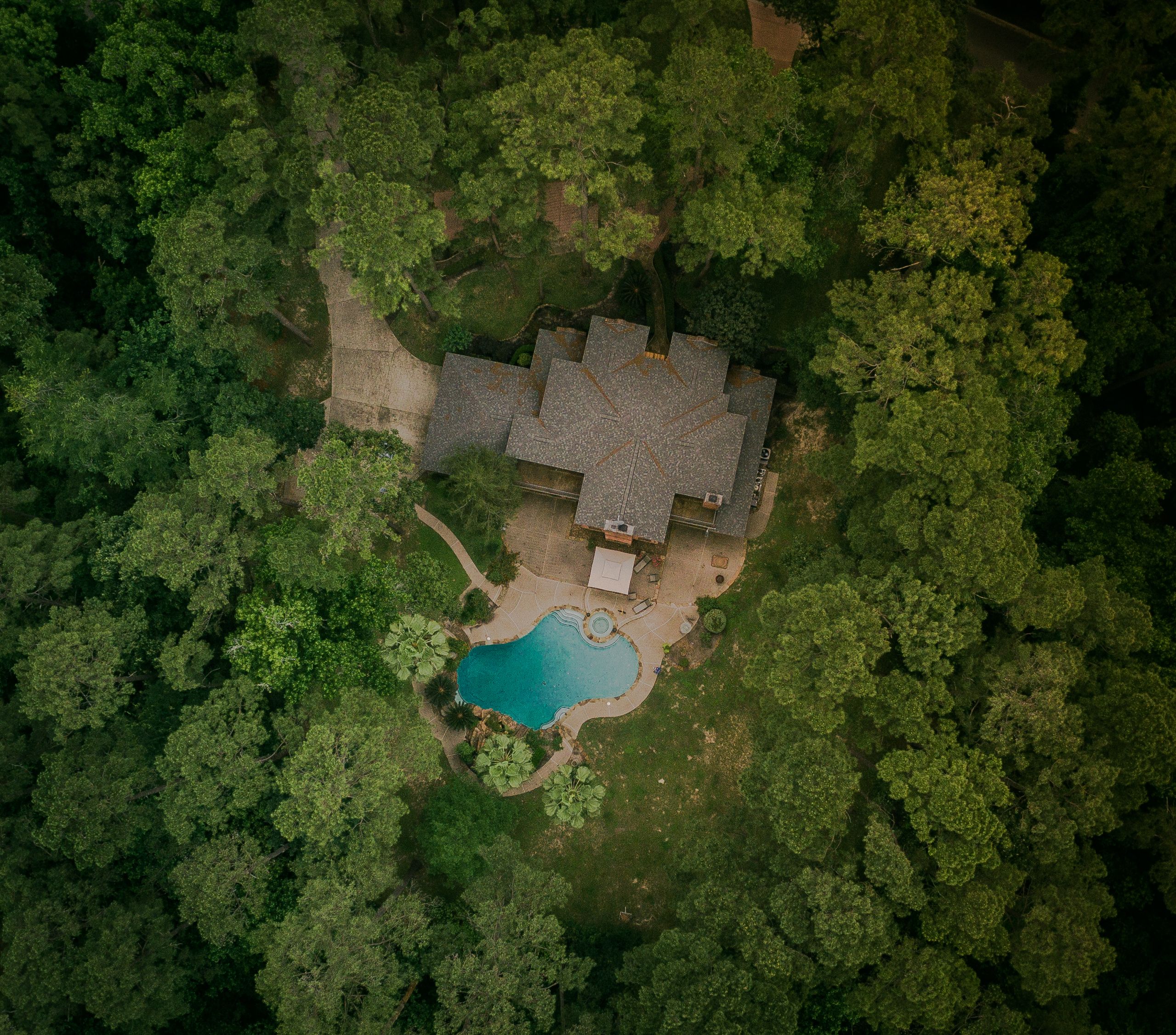 Aerial view of a home surrounded by trees in North Texas